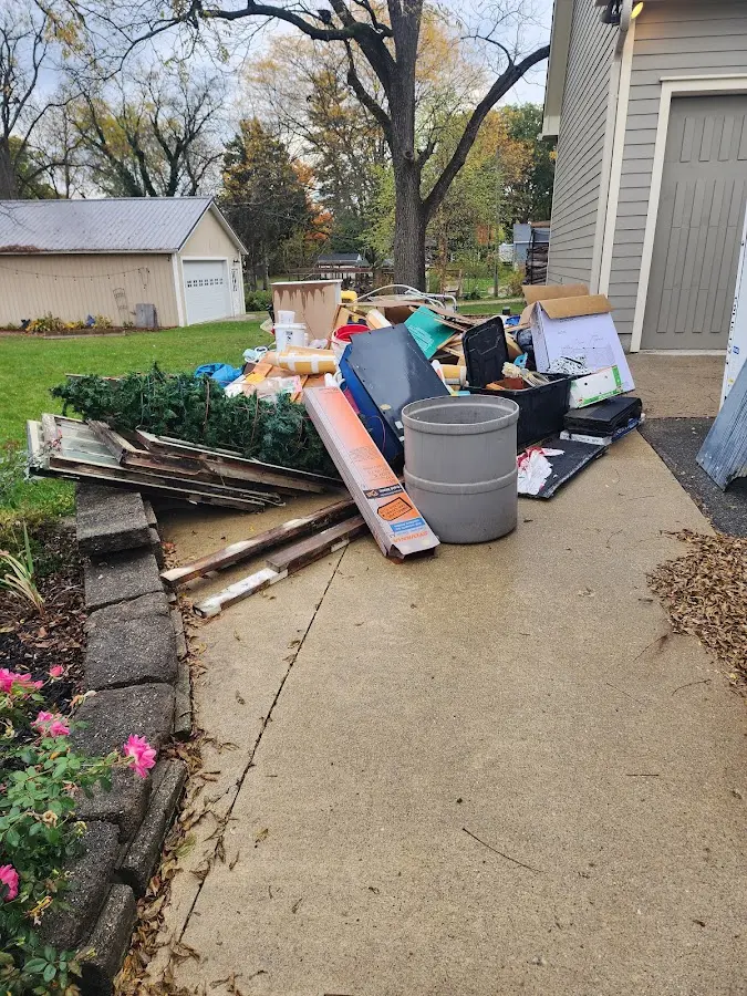 Dumpster being loaded with debris for Roofing Dumpster Rental in Canfield